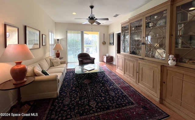 living room with hardwood / wood-style floors and ceiling fan