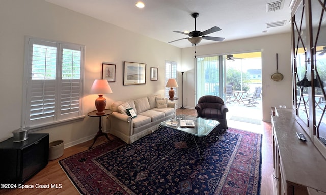 living room featuring hardwood / wood-style flooring, plenty of natural light, and ceiling fan