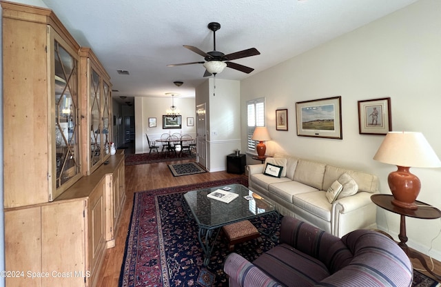 living room featuring hardwood / wood-style floors, a textured ceiling, and ceiling fan