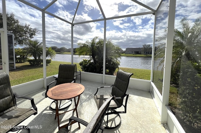 sunroom / solarium featuring a water view