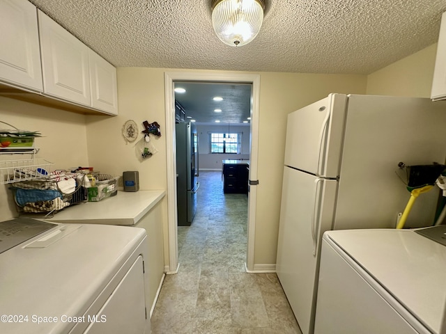 laundry area featuring cabinets and a textured ceiling