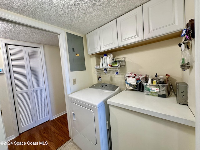 clothes washing area featuring cabinets, separate washer and dryer, dark hardwood / wood-style flooring, electric panel, and a textured ceiling