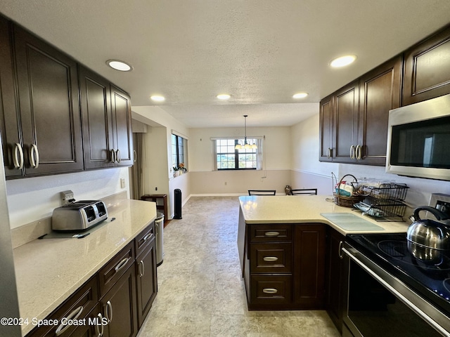 kitchen featuring stainless steel appliances, kitchen peninsula, pendant lighting, a textured ceiling, and dark brown cabinets