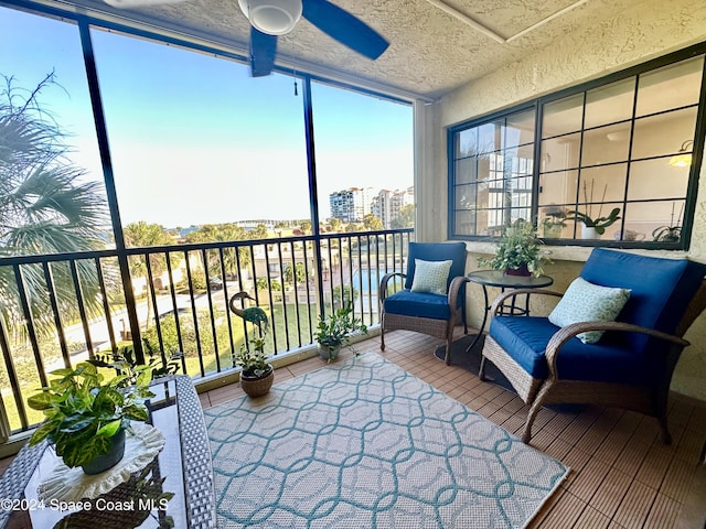 sunroom / solarium featuring ceiling fan