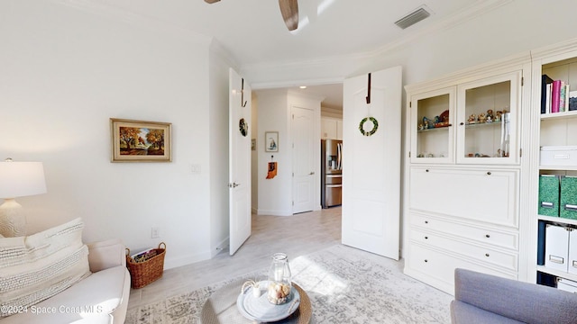 living room with ceiling fan and ornamental molding