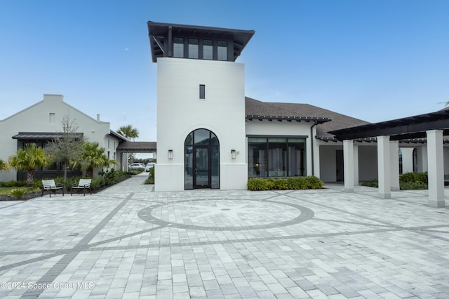 rear view of house featuring french doors