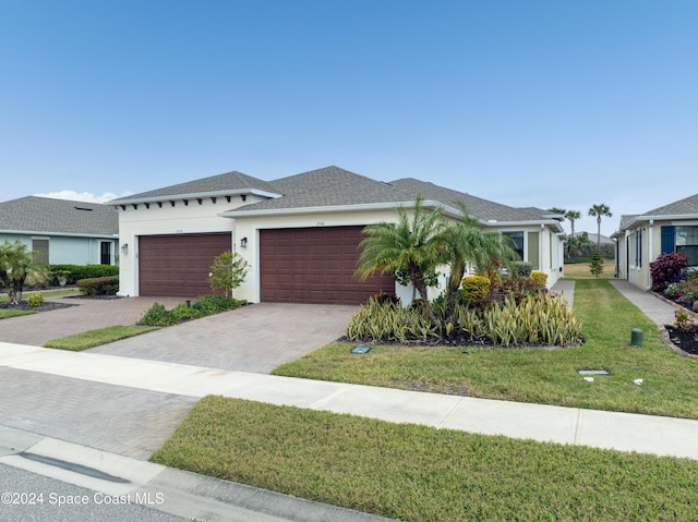 view of front of property featuring a garage and a front yard