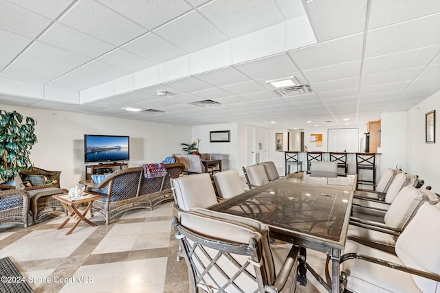 dining room featuring a drop ceiling