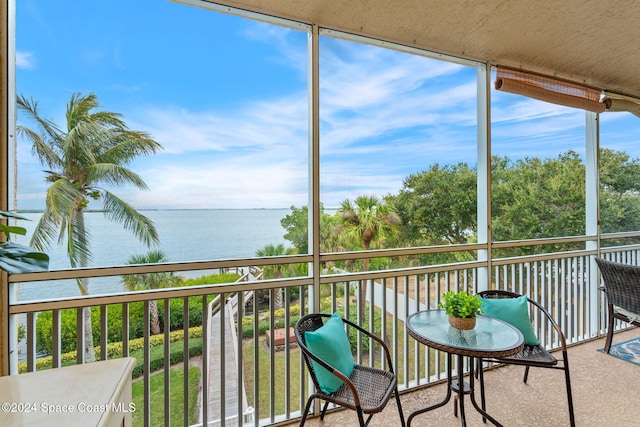 sunroom / solarium with a water view