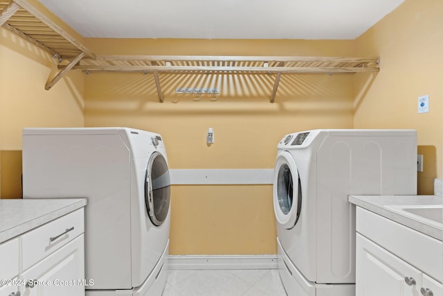 washroom with cabinets and separate washer and dryer