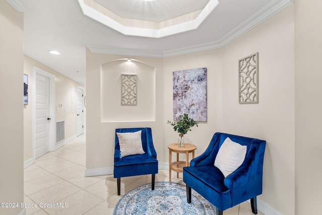 living area with a raised ceiling, crown molding, and light tile patterned flooring