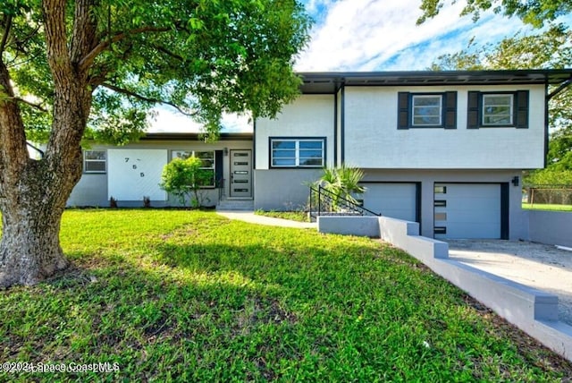 view of front facade with a front yard and a garage