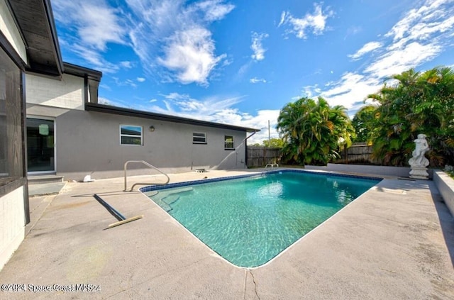 view of swimming pool featuring a patio area