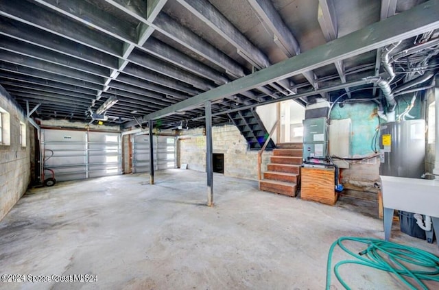 basement featuring electric water heater and a wealth of natural light