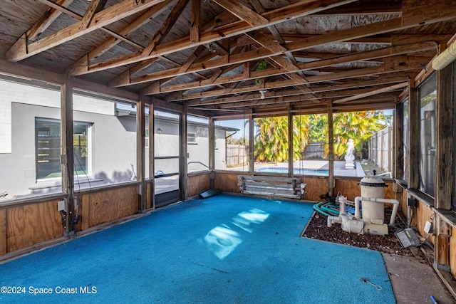 unfurnished sunroom with vaulted ceiling