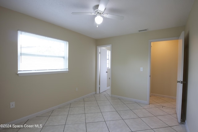 unfurnished bedroom featuring ceiling fan and light tile patterned flooring