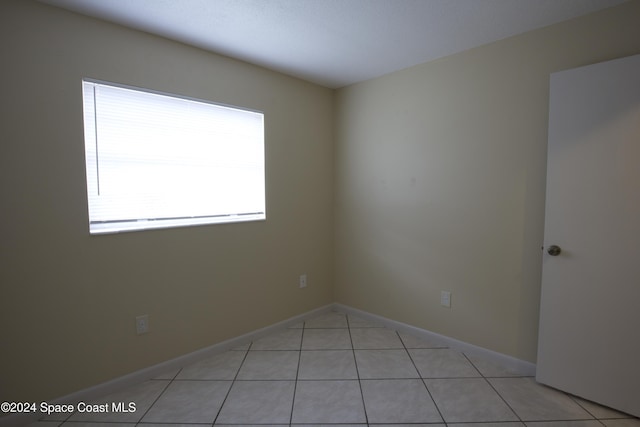 tiled spare room with a wealth of natural light