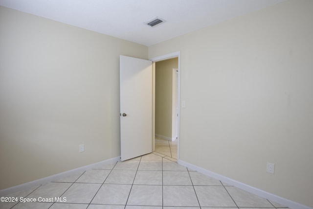 empty room with light tile patterned floors