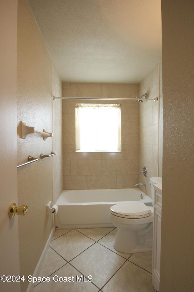 full bathroom with tile patterned flooring, tiled shower / bath combo, toilet, and vanity