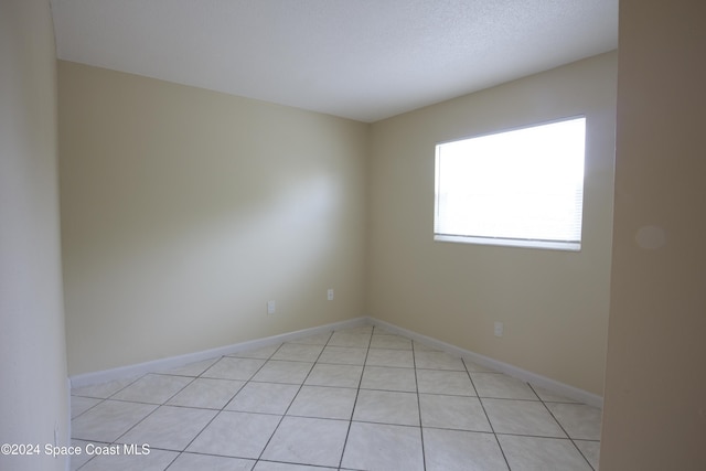 spare room with light tile patterned floors