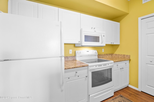 kitchen with white cabinetry, light hardwood / wood-style flooring, and white appliances