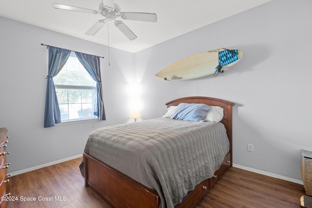 bedroom with dark hardwood / wood-style floors and ceiling fan