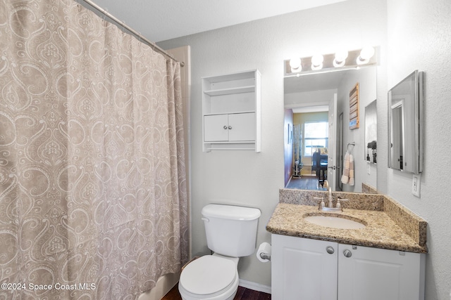 bathroom with a shower with curtain, vanity, and toilet