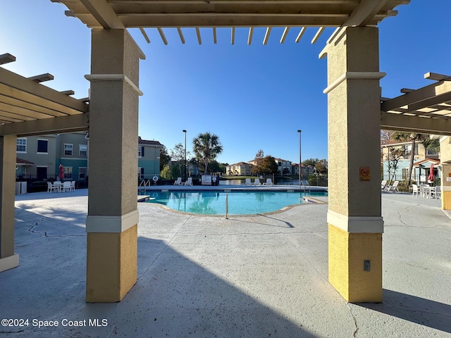 view of swimming pool with a pergola and a patio area