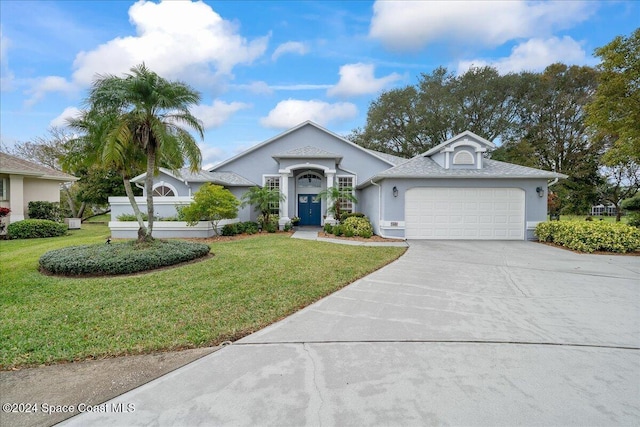 view of front facade featuring a front yard and a garage