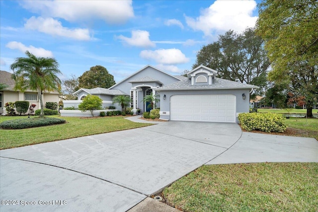 view of front of home with a garage and a front lawn