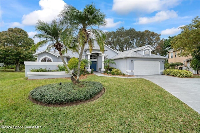 view of front of house with a garage and a front yard