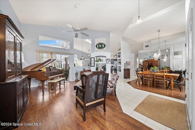 living room with tile patterned flooring, high vaulted ceiling, and ceiling fan