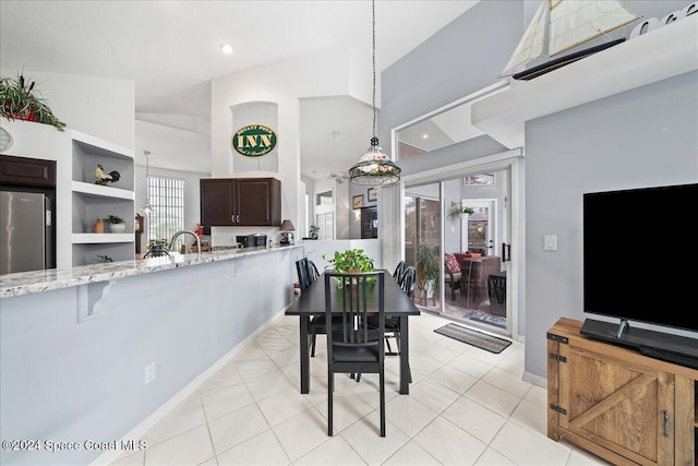 tiled dining space with vaulted ceiling