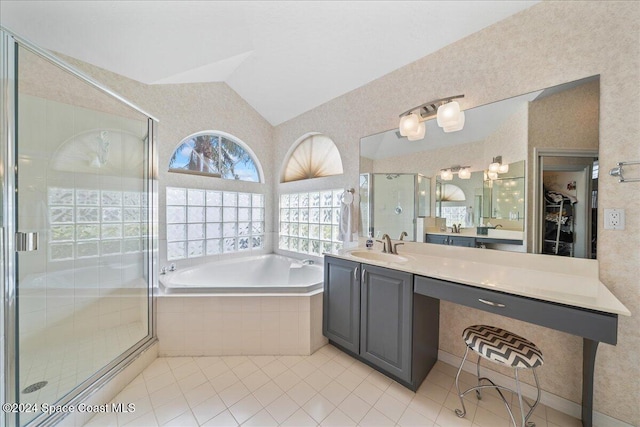 bathroom featuring tile patterned floors, vanity, separate shower and tub, and lofted ceiling