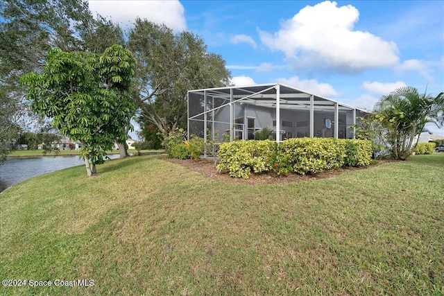 view of yard featuring a lanai and a water view