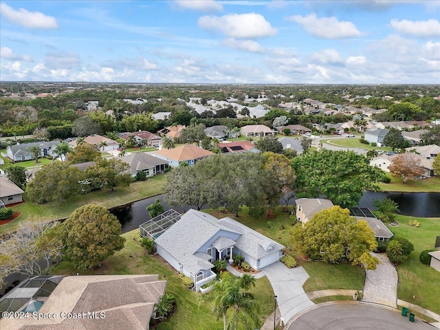 birds eye view of property with a water view