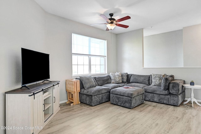 living room featuring ceiling fan and light hardwood / wood-style floors