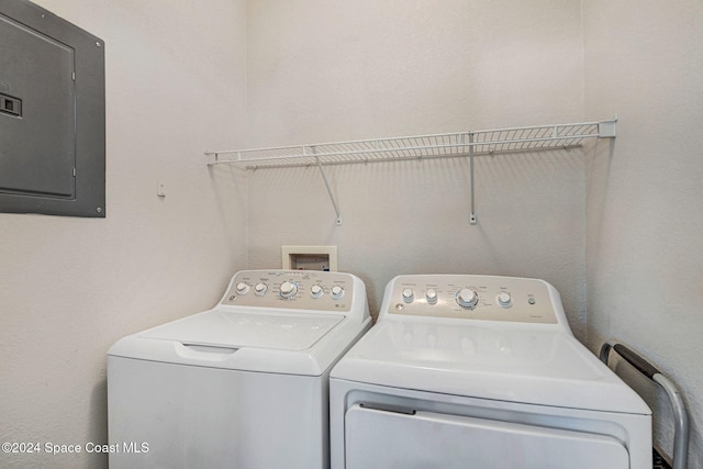 clothes washing area featuring washer and dryer and electric panel