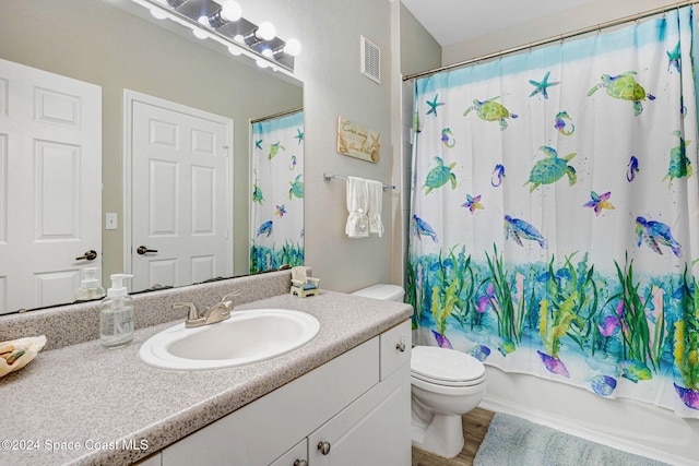 full bathroom with shower / tub combo, vanity, hardwood / wood-style flooring, and toilet