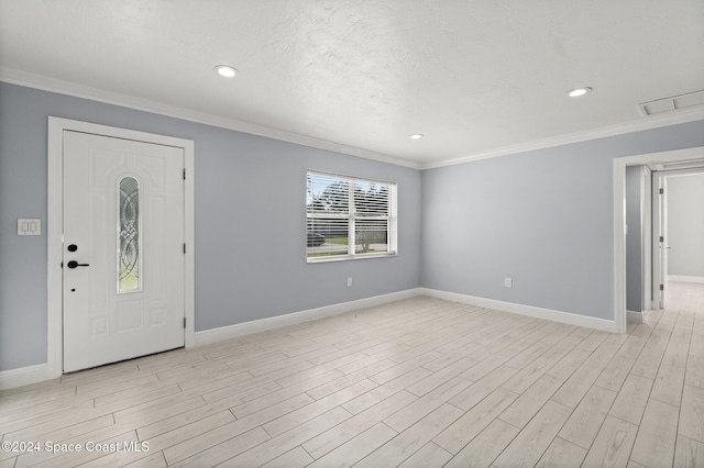 entrance foyer with light hardwood / wood-style floors and crown molding