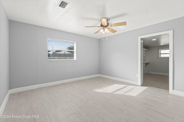 empty room with light hardwood / wood-style floors and ceiling fan