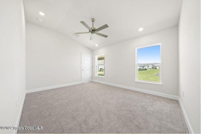 spare room with light carpet, ceiling fan, and lofted ceiling