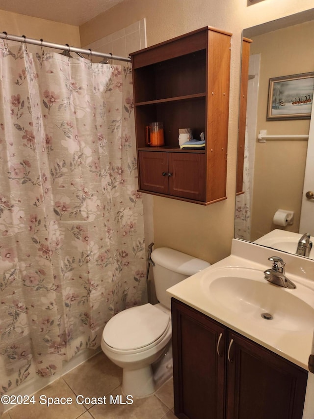 bathroom featuring toilet, vanity, tile patterned floors, and a shower with shower curtain