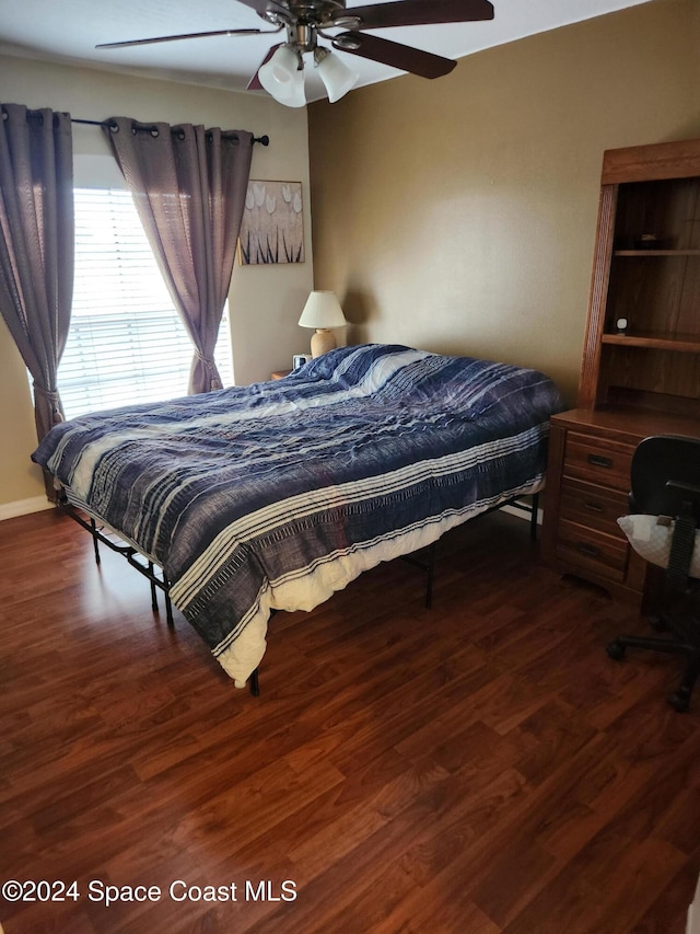 bedroom with dark hardwood / wood-style floors and ceiling fan