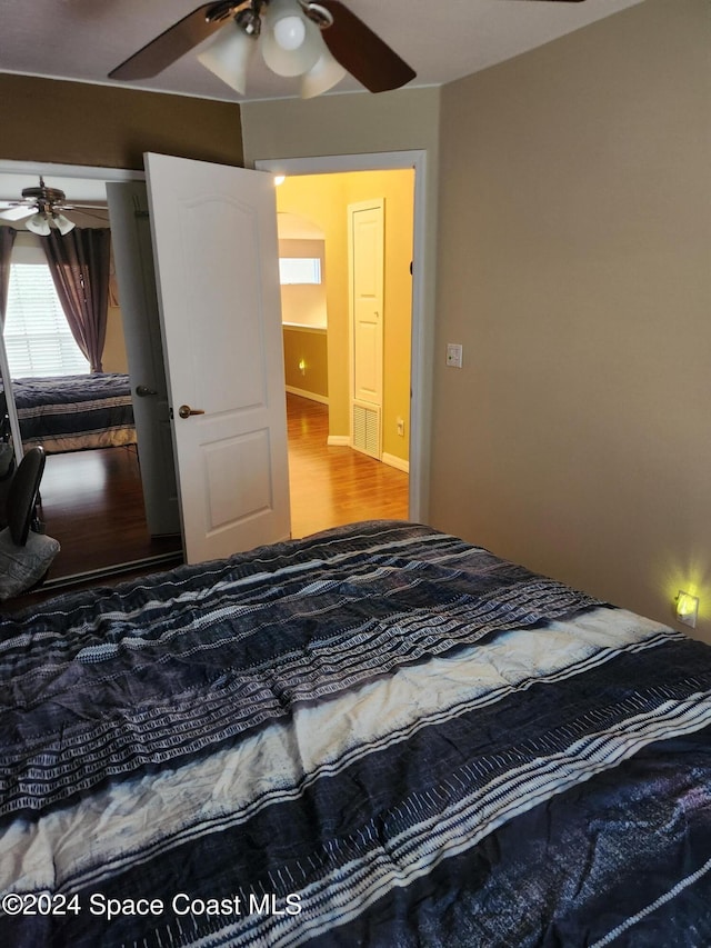 bedroom with hardwood / wood-style flooring and ceiling fan