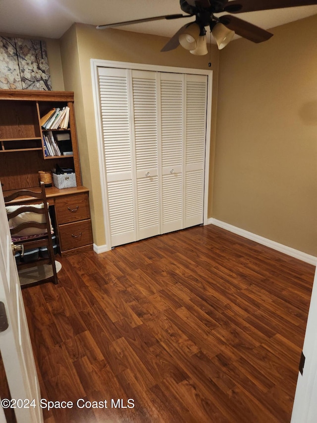 unfurnished office featuring dark hardwood / wood-style floors and ceiling fan