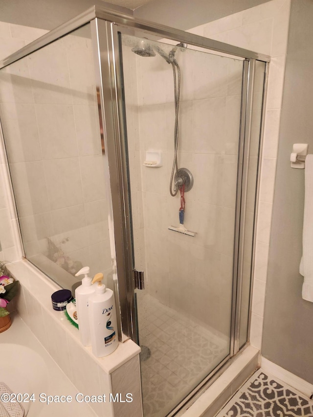 bathroom with tile patterned flooring and an enclosed shower