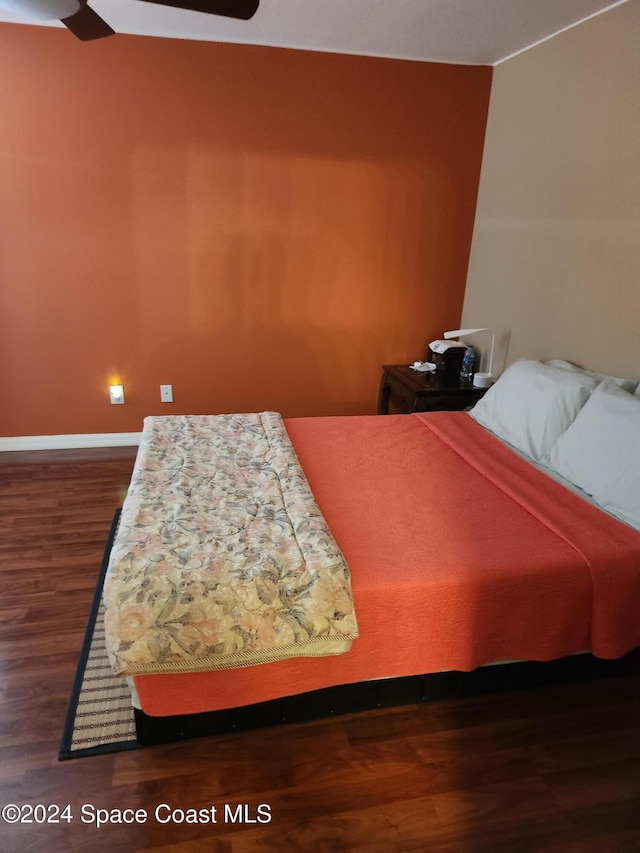 bedroom with ceiling fan and dark hardwood / wood-style flooring