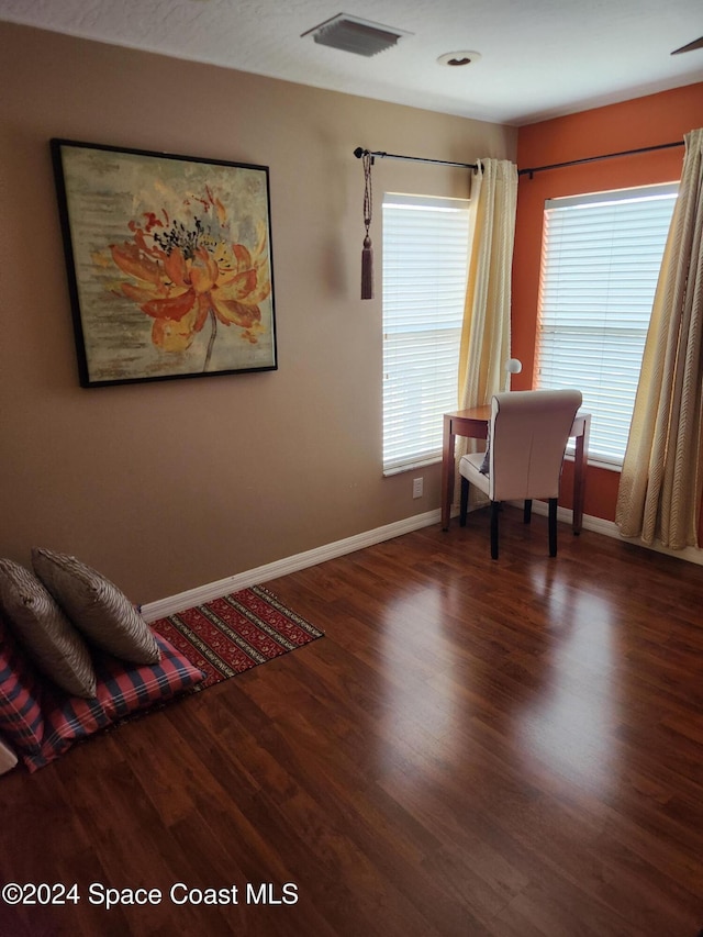 home office with dark hardwood / wood-style floors