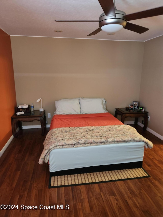 bedroom with ceiling fan and dark hardwood / wood-style floors